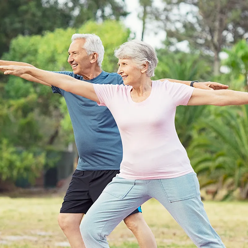 Senior couple doing physical exercises outdoor